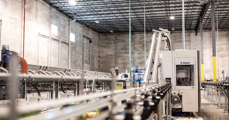 an empty, non-functioning assembly line in a manufacturing facility