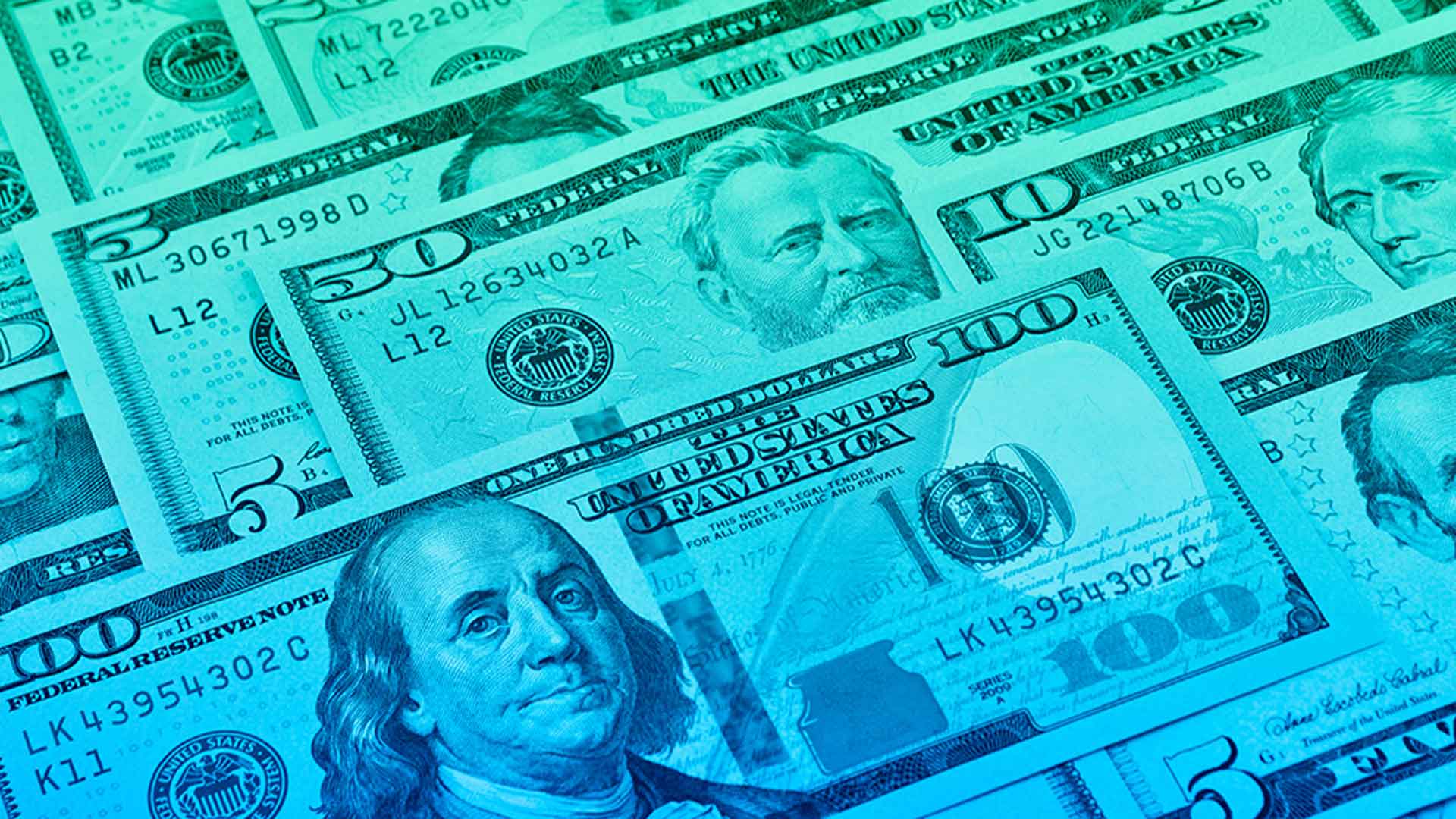 a variety of american dollar bills laying flat